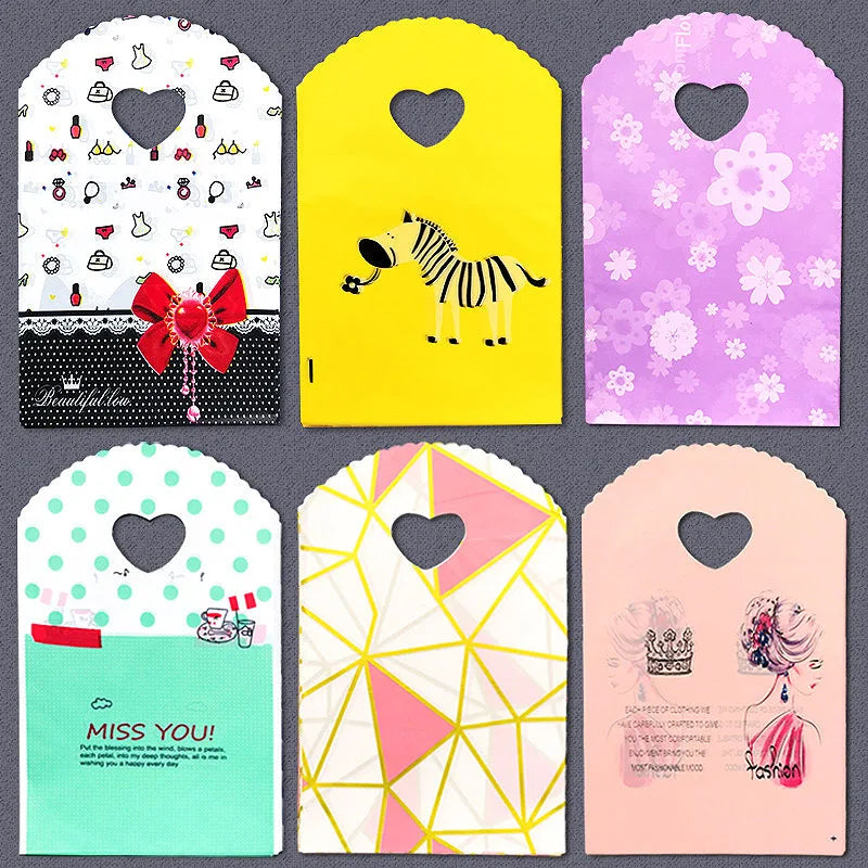 50pcs/lot Various Patterns Jewelry Plastic Bag Heart-Shaped Oval Handles Mini Gift Packing Bag Store Small Shopping Bags